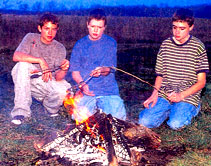 The authors sons Robbie and Kevin Reynolds (along with friend Ryan Bush) at the family farm, roasting soy hot dogs.